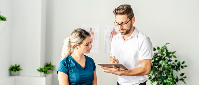 chiropractor discussing wellness care with patient